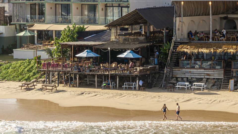 A beach club on the sand at golden hour