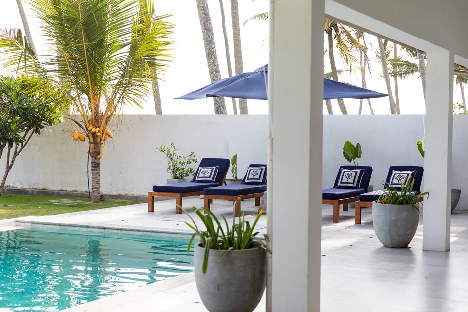 Loungers and umbrellas beside the infinity pool