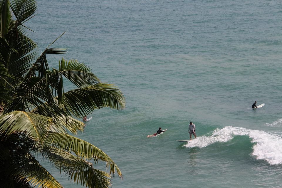 Surfing the reef break in front of the villa