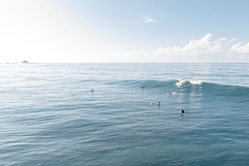 Surfers waiting on a glassy line-up